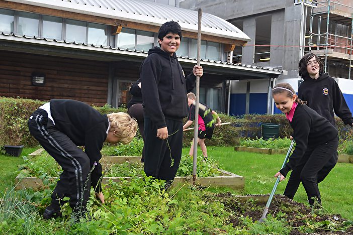 school pupils tend their allotment funded by Dorset Community Foundation