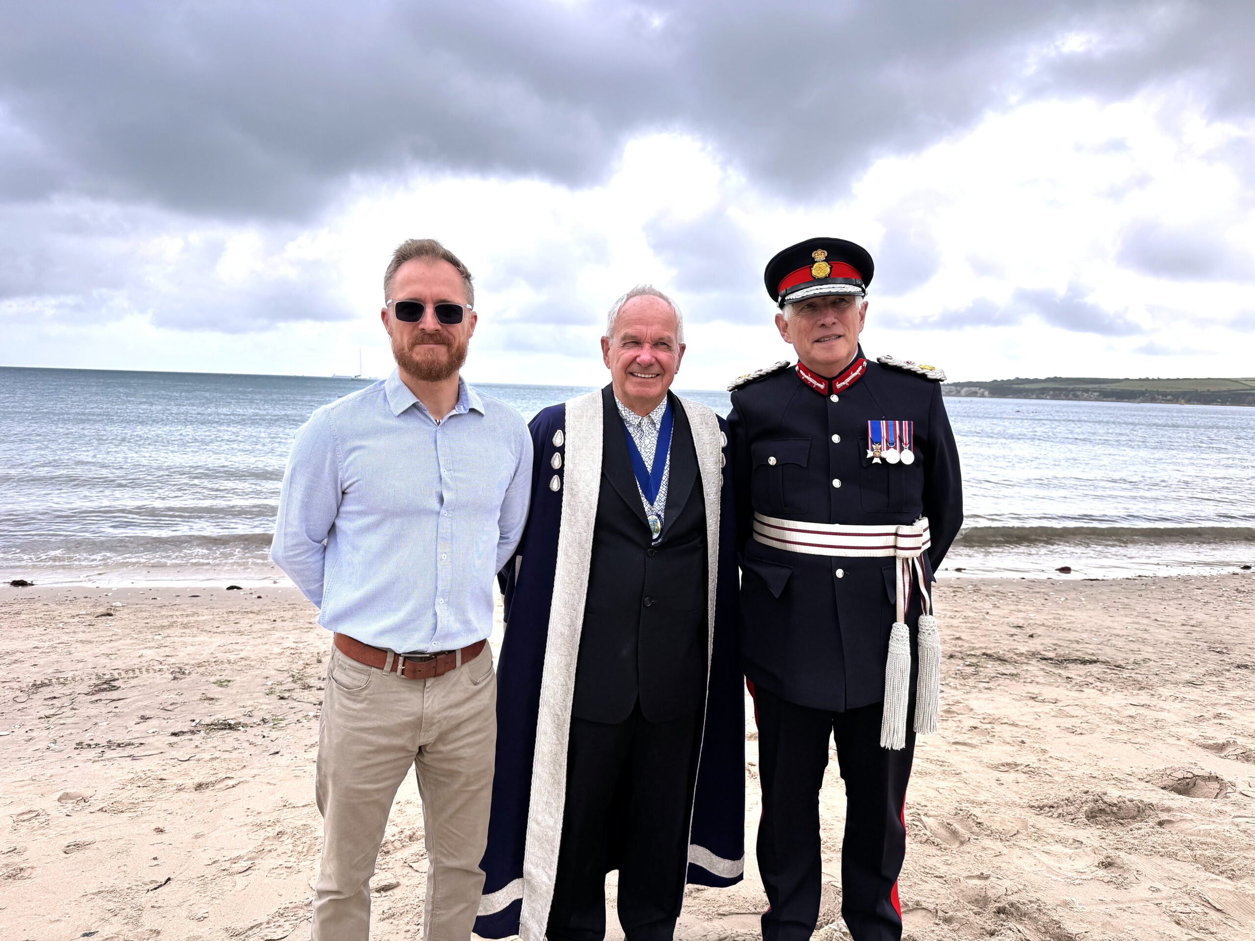 Dorset Community Foundation Chair Tom Flood CBE, centre, and Dorset Lord-Lieutenant Michael Dooley and DCF Philanthropy Director Gareth Owens at Knoll Beach, Studland, for the launch of the Green Futures Fund
