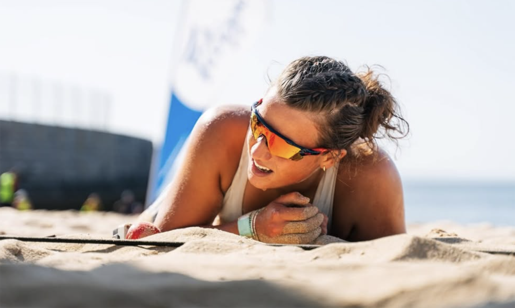 A picture of rower Lexi Gill, who has received a £1,000 Young and Talented sports grant, after diving in the sand to finish a beach sprint race
